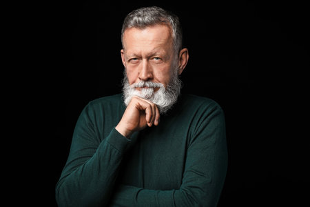 Portrait of handsome senior man on dark background