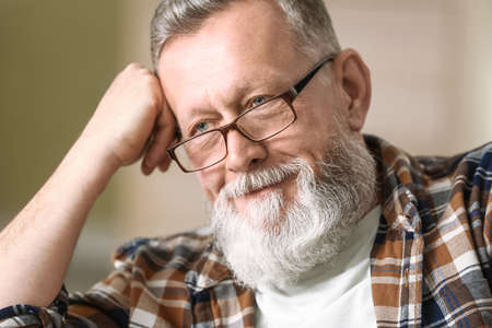 Portrait of handsome senior man at home