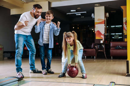 Family playing bowling in clubの写真素材