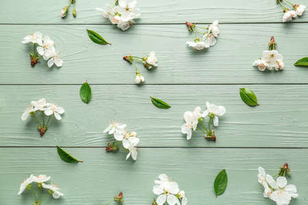 Beautiful flowers and leaves on wooden background