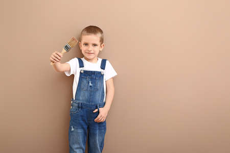 Little boy with brush near color wallの写真素材