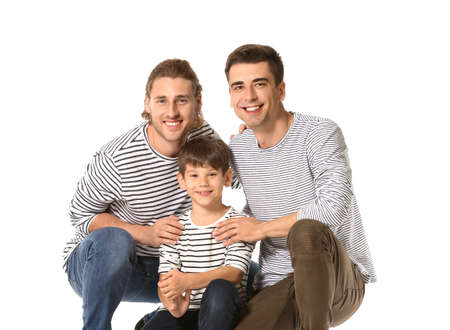 Happy gay couple with adopted child on white background