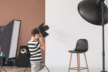 Cute little photographer in professional studioの写真素材