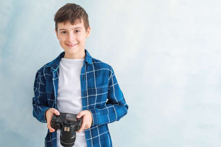 Cute little photographer on color backgroundの写真素材