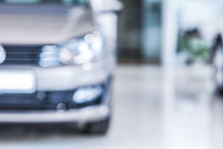 Modern car in showroom, blurred view