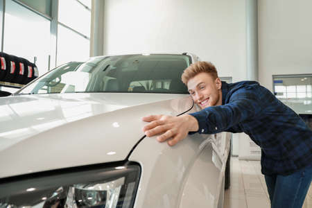 Man choosing new car in salon