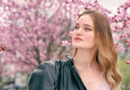 Portrait of beautiful young woman in park on spring dayの写真素材