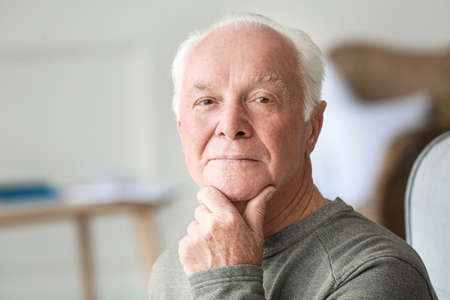 Portrait of elderly man at home