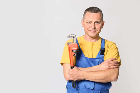 Handsome plumber on gray backgroundの写真素材