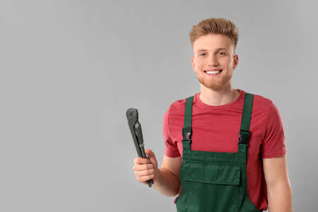 Handsome plumber on gray backgroundの写真素材