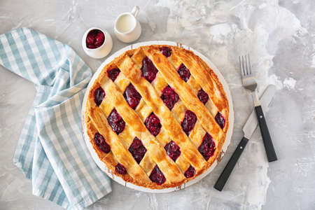 Tasty cherry pie on table