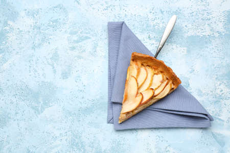 Piece of tasty apple pie on color backgroundの写真素材