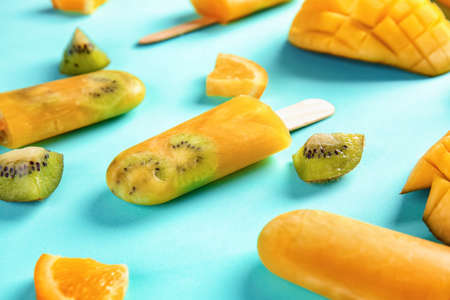 Tasty fruit ice cream on color backgroundの写真素材