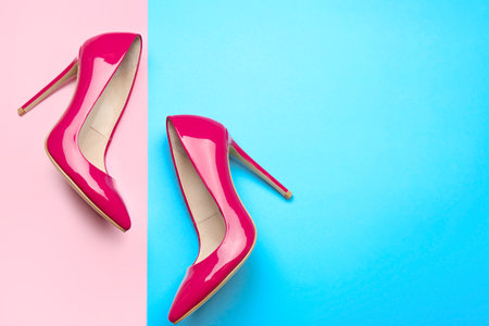 Stylish high heeled shoes on color backgroundの写真素材