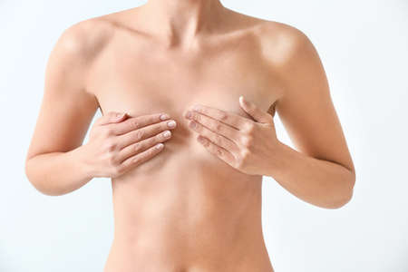 Naked woman on light background. Concept of breast augmentationの写真素材