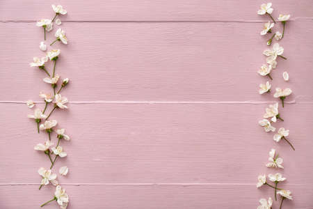 Beautiful blooming branches on color wooden background