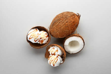 Tasty coconut ice cream on gray background