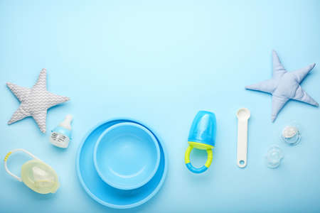 Baby nibbler with accessories on color backgroundの写真素材