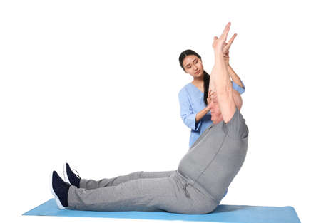 Young Asian physiotherapist working with senior man on white background