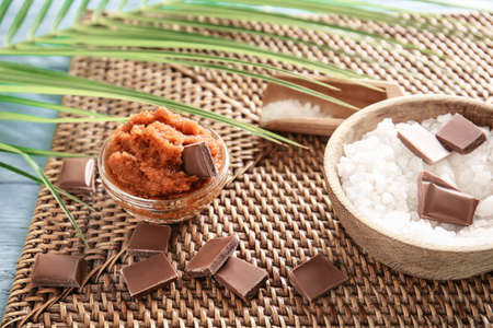 Bowl with chocolate body scrub and ingredients on tableの写真素材