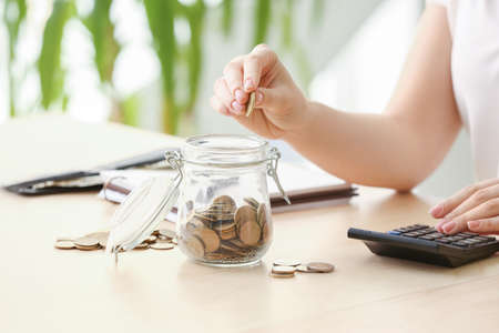 Young woman counting money at table, closeup