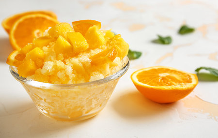 Bowl with tasty shaved ice on light tableの写真素材