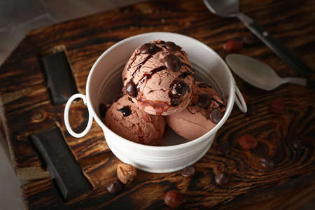 Bowl with tasty chocolate ice cream on table