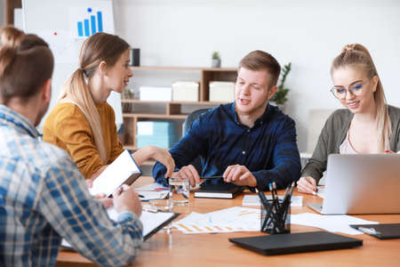 Group of young people at business meeting in office