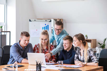 Group of young people at business meeting in office