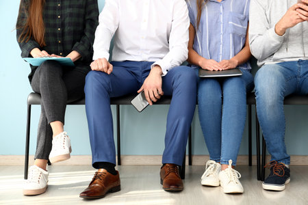 Young people waiting for job interview indoorsの写真素材