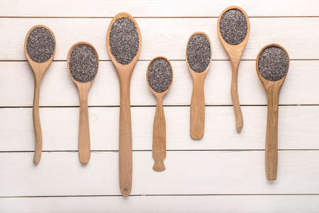 Spoons with chia seeds on wooden tableの写真素材