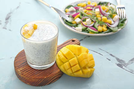 Glass of tasty mango dessert on tableの写真素材