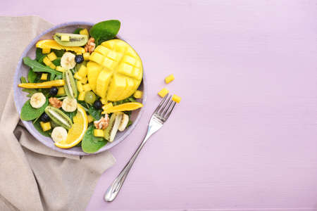 Plate with tasty mango salad on color backgroundの写真素材