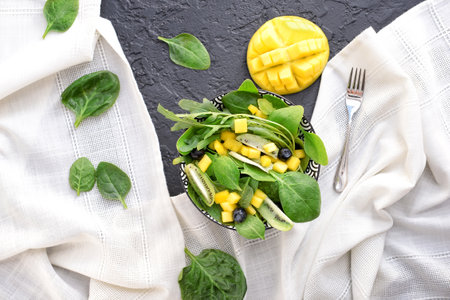 Bowl with tasty mango salad on grunge backgroundの写真素材