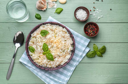 Plate with tasty risotto on wooden tableの写真素材