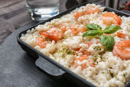 Frying pan with tasty risotto on table, closeupの写真素材