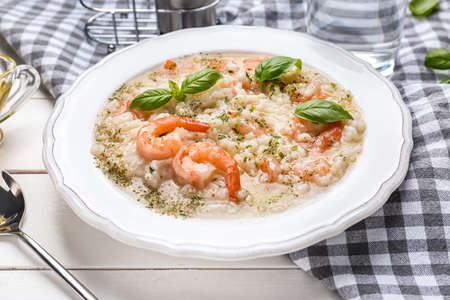 Plate with tasty risotto on tableの写真素材
