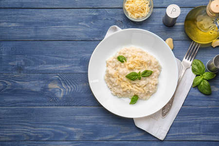 Plate with tasty risotto on wooden tableの写真素材