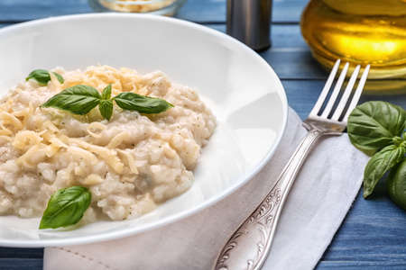 Plate with tasty risotto on tableの写真素材
