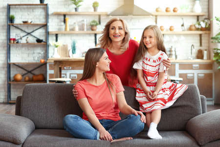 Happy girl with her mother and grandmother at home