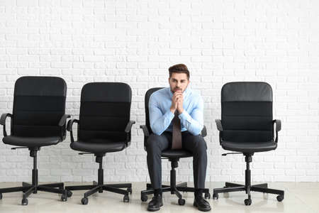 Young man waiting for job interview indoorsの写真素材