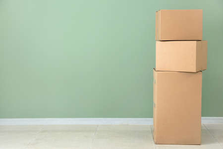 Cardboard boxes near color wall