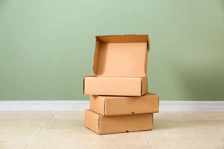 Cardboard boxes near color wallの写真素材