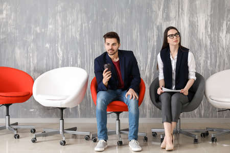 Young people waiting for job interview indoorsの写真素材