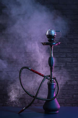 Hookah with fume on dark background