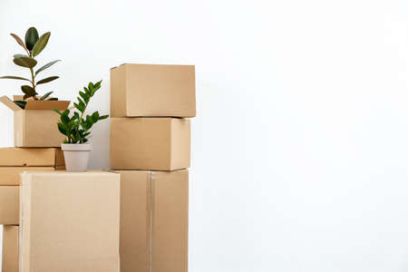Cardboard boxes with belongings prepared for moving into new house on white backgroundの写真素材