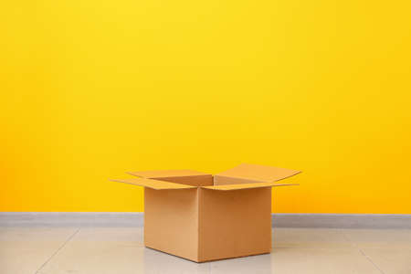 Cardboard box near color wallの写真素材