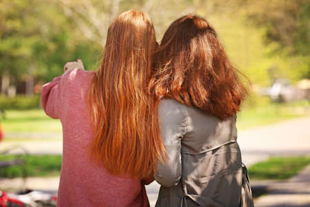 Beautiful young women in park, back viewの写真素材