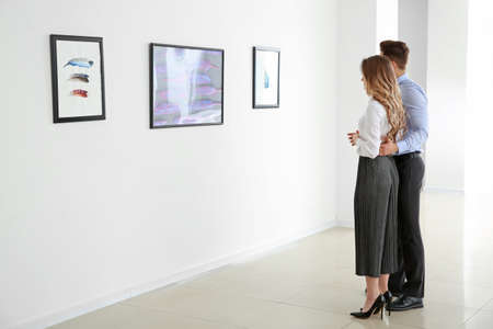 Couple at exhibition in modern art galleryの写真素材