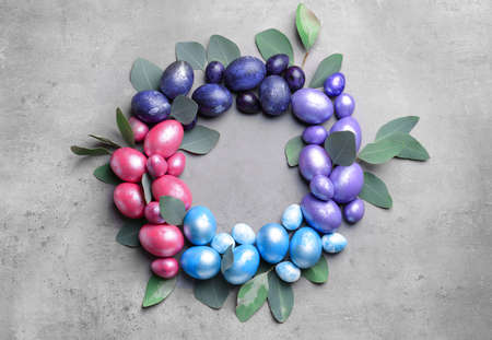 Frame made of beautiful Easter eggs on gray background